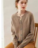 100 % cashmere short cardigan, round neckline, button-front, ribbed cuffs, soft camel—lightweight luxury for spring-to-fall outfits.
