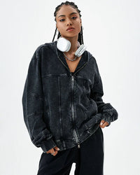 Woman street-styling a 100 % cotton retro-washed zip-up hoodie, sun-fade sand tone and raw-edge seams give lived-in 90s vibes—420 gsm fleece keeps you cozy on breezy 60-75 °F spring-fall nights.