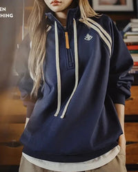A quietly versatile pullover that softens the structure of a stand collar with a loose, easy fit.
