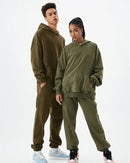 Street-shot of unisex batik-washed cotton hoodie, sun-fade tones and distressed patchwork give lived-in 90s attitude—420 gsm fleece keeps you warm on breezy 55-70 °F spring nights.