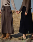 Woman strolling in a Cashmere & Wool Blend Knitted Long Skirt, 70 % wool / 30 % cashmere rib drapes like jersey—your luxe yet breathable 60-75 °F spring-fall staple.
