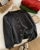 Women’s Korean-style O-neck cardigan with single-breasted pearl buttons and long sleeves—soft layer for autumn cafés, office days or weekend layering.