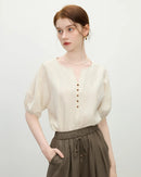 Women's apricot minimalist loose short-sleeved shirt featuring a small V-neck and slim sleeves, perfect for casual summer  fashion and everyday comfort.