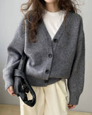 Polyester cropped V-neck cardigan, pearl buttons, ribbed cuffs, heather taupe—lightweight luxury for spring-to-fall layering or solo wear.