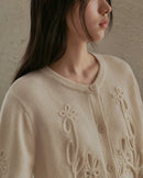 Flat-lay of oatmeal double-faced wool cardigan, ribbed cuffs and matte buttons—lightweight yet cozy for transitional winter weather .