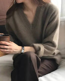 Gentle Herd slouchy V-neck wool sweater, relaxed fit, ribbed cuffs, heather taupe—soft merino warmth for winter layering or solo wear.