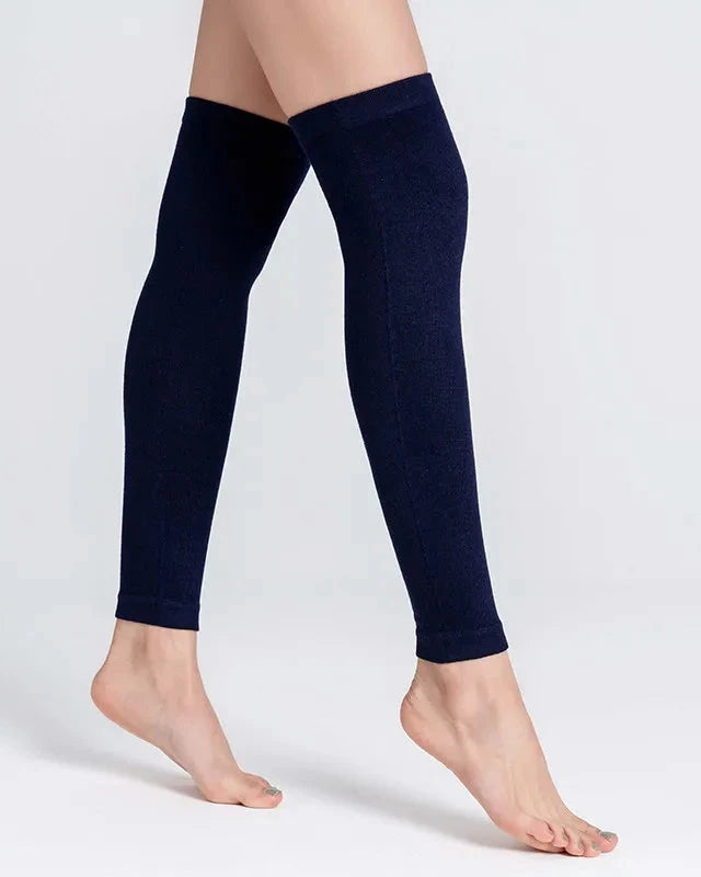 A pair of knit cotton blend leg warmers with a 3D stretch wrap, designed for a secure fit that stays put under boots and skirts all day.