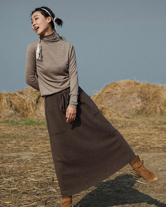 Woman strolling in a Cashmere & Wool Blend Knitted Long Skirt, wool rib drapes like jersey—your luxe yet breathable 60-75 °F spring-fall staple.