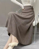 Women’s high-waisted A-line cashmere skirt in soft taupe, midi length with subtle flare, flat elasticized waistband, 100 % cashmere rib knit, pull-on ease, cool-season office or weekend essential