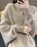 Woman street-styling a Hooded 100 % Wool Knitted Sweater, 19.5 micron superfine Merino drapes like jersey—your cozy yet breathable 45-65 °F fall-to-spring layer.