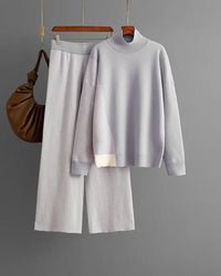 Woman brunching in a pastel knitted color-block sweater set—relaxed crew-neck top and high-rise midi skirt—soft wool blend keeps you cozy yet camera-ready on breezy spring mornings.