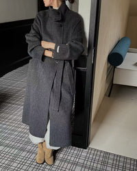 Side angle of model belted in max-length coat, wind-blocking flap front and brushed wool keep warmth without bulk on coldest days.