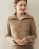 Woman sipping coffee in latte cashmere v-neck pullover, tightly knitted 2-ply Mongolian fibers drape softly for breathable winter warmth .