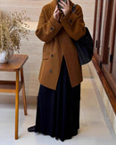 Woman cinches camel belt on long wrap coat, luxe alpaca-wool blend drapes like cashmere for cold-weather elegance without bulk .