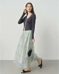 Woman twirling in a lightweight mesh cake skirt, voluminous A-line tiers add playful movement to casual daytime looks.