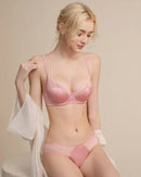 Woman lounging in the French New Lace Soft Underwire Bra Set, 90 % nylon / 10 % spandex lace and memory-alloy underwire give invisible lift—your breathable 70-85 °F summer-to-fall essential that vanishes under backless tops .