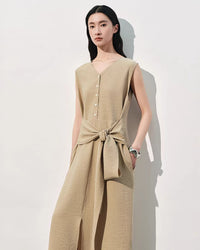 Front view of a women's elegant V-neck sleeveless dress featuring a delicate tie-up waist detail and a high side slit, perfect for a sophisticated summer look.