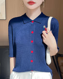 Short-sleeved women's knitted cardigan made from soft worsted wool. Features a classic polo collar and a vibrant embroidered flamingo design with delicate bead accents.