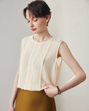 This of a women's solid color sleeveless silk shirt featuring delicate lace trim and a lightweight ghost crepe texture, perfect for Spring and Summer office wear. 