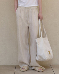 Elevate your warm-weather wardrobe with our relaxed linen drawstring wide leg pants.