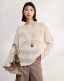 Apricot loose fitting striped slightly sheer knit t shirt crafted from a breathable silk rayon blend, featuring a delicate open weave texture and rolled boat neck, perfect for spring layering, 