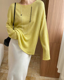 Discover our sheer lightweight knit top with boat neck, oversized sleeves, and breathable fabric.