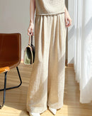 Front view of beige high-waisted wide-leg pants made from a breathable linen blend fabric, designed for women's summer comfort and style.