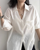  Casual oversized V-neck shirt for women, featuring a relaxed silhouette, button closure, and a flowy drape suitable for spring and summer wear.
