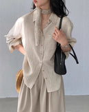 Women's loose-fit button-down shirt made from a breathable linen blend, featuring a classic collar and a comfortable silhouette perfect for summer fashion.