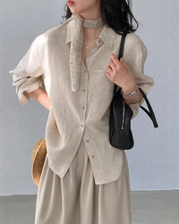 Women's loose-fit button-down shirt made from a breathable linen blend, featuring a classic collar and a comfortable silhouette perfect for summer fashion.