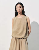 Apricot mulberry silk sleeveless tank top for women featuring a loose fit and crew neck design, crafted for lightweight comfort and a textured jacquard finish.