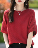 Stylish women's mid-sleeve knitted sweater designed for plus-size figures. This comfortable top features a relaxed fit and a classic knit texture perfect for layering.