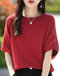 Stylish women's mid-sleeve knitted sweater designed for plus-size figures. This comfortable top features a relaxed fit and a classic knit texture perfect for layering.
