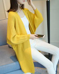 Women's Knitted long cardigan featuring dramatic batwing sleeves and a V-neck open front, crafted for medium stretch comfort with a loose fit that drapes effortlessly from office to evening.
