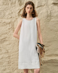 Front view of a women's summer solid color A-shaped vest dress featuring a niche design with handmade bead edge detailing, crafted from a breathable Tencel and linen blend.
