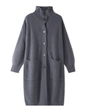 Wrap yourself in soft luxury with Gentle Herd’s longline knit cardigan. This stand collar wool features ribbed texture and functional pockets, perfect for cozy layering all season long.