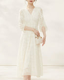 Women's silk dress featuring intricate [Pattern] embroidery and elegant three-quarter sleeves, offering a sophisticated silhouette perfect for formal events.