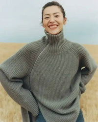 Oversized 100 % cashmere sweater, irregular diagonal zipper at high neck, dropped shoulders, ribbed cuffs, heather taupe—runway-ready winter layer for him or her.