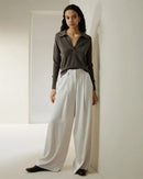 Woman brunching in the Cashmere V-Neck Versatile Polo Sweater, 19-micron Mongolian fibers and two-button placket give luxe polish—your breathable 60-75 °F spring-fall staple.