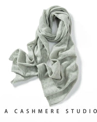 Woman looping a Pure Cashmere Hollow-Out Long Scarf, 19-micron Inner-Mongolia cashmere and open-work lattice knit give cloud-soft warmth—your wind-proof 35-55 °F fall-through-spring wrap that doubles as a blanket on flights.