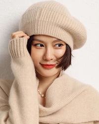 Woman tilting her head in a Pure Cashmere Knitted Beret, 19-micron Inner-Mongolia cashmere and hand-finished crown give cloud-soft warmth—your luxe yet breathable 45-65 °F fall-through-spring accent.