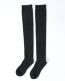 100 % cashmere knee-high socks, ultra-fine 2-ply knit, hand-linked toe, soft camel—cloud-soft warmth for winter lounging or in-boot layering.