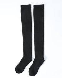 100 % cashmere knee-high socks, ultra-fine 2-ply knit, hand-linked toe, soft camel—cloud-soft warmth for winter lounging or in-boot layering.