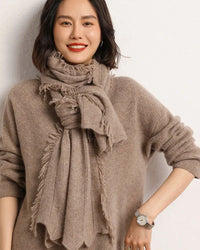 Woman looping a Pure Cashmere Knitted Scarf, 19-micron Inner-Mongolia cashmere and 200 × 35 cm rib knit give cloud-soft warmth—your wind-proof 35-55 °F fall-through-spring wrap that doubles as a blanket on flights.