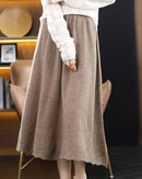 Woman twirling in the Pure-Wool A-Line Skirt, 100 % superfine Merino and midi flare give vintage polish—your wind-proof 45-65 °F fall-through-spring essential.