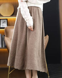 Woman twirling in the Pure-Wool A-Line Skirt, 100 % superfine Merino and midi flare give vintage polish—your wind-proof 45-65 °F fall-through-spring essential.