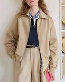Woman layering a sand-beige retro workwear jacket, boxy cropped cut and triple-stitched seams nod to vintage Detroit styles—perfect lightweight layer for 60-75 °F spring-fall commutes.