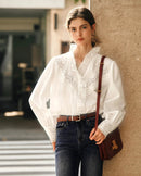 Women's elegant cotton blouse featuring delicate ruffled trim, intricate embroidered hollow-out patterns, and V-neck design — perfect for spring brunches or office chic styling.