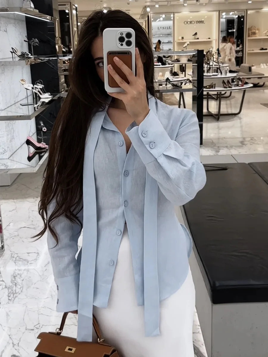 Cut slim to follow the body's natural line, it opens fully at the front and ties at the waist with a softly draped ribbon that adds a feminine, editorial touch.