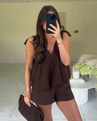 Bow decoration V-neck sleeveless backless top and drawstring mini shorts 2-piece set in polyester blend. Slim fit — a chic solid high street summer suit for women.